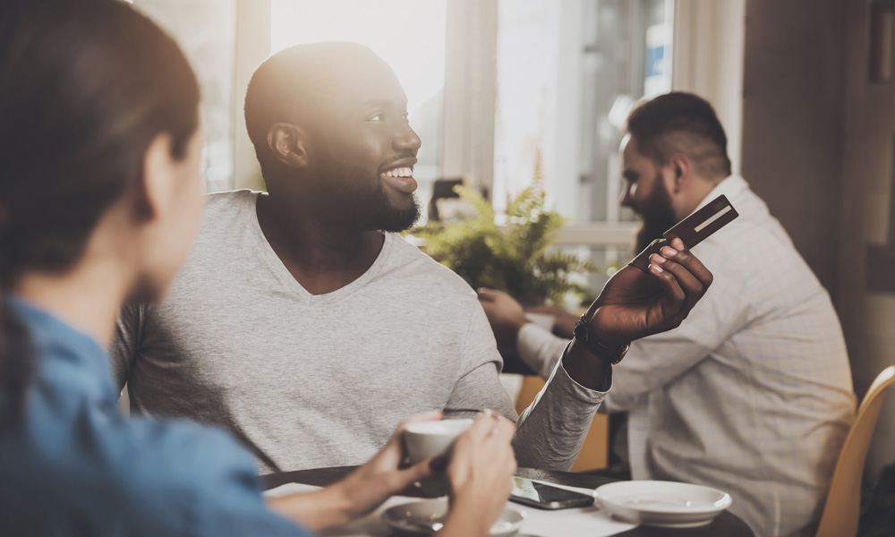 Man paying for dinner with credit card