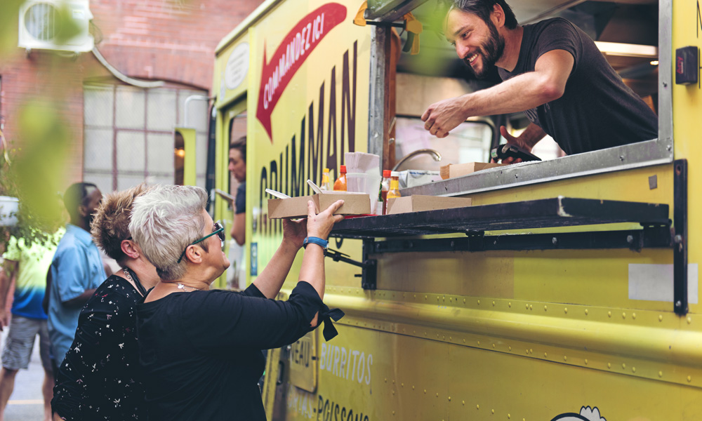 Woman making a payment at a foodtruck